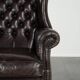 Dark brown cowhide Chesterfield wingback armchair in classic English style