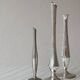 Set of three lightweight silver-coloured metal vases.
