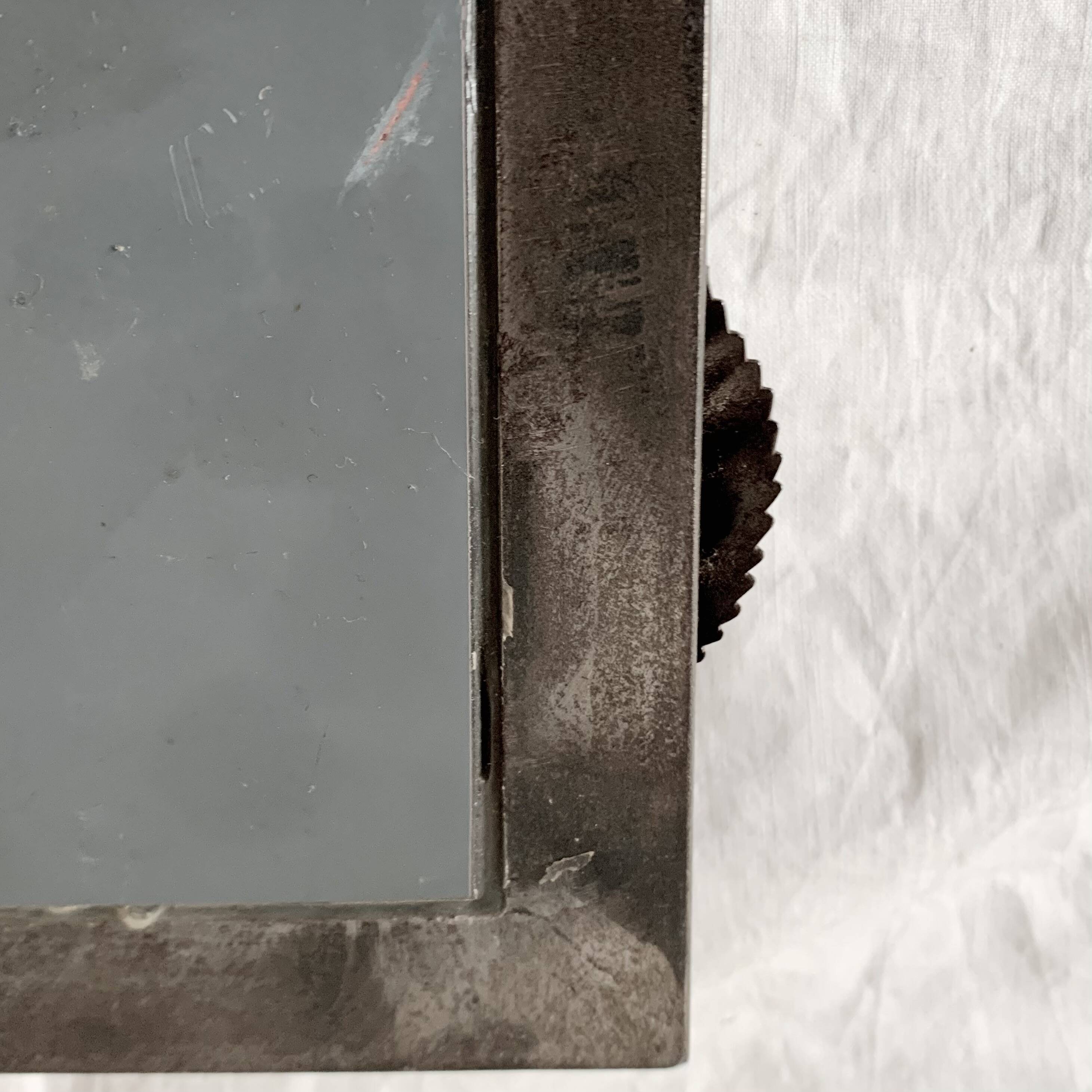 Vintage wall mirror in varnished steel decorated with a rose in relief