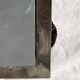 Vintage wall mirror in varnished steel decorated with a rose in relief