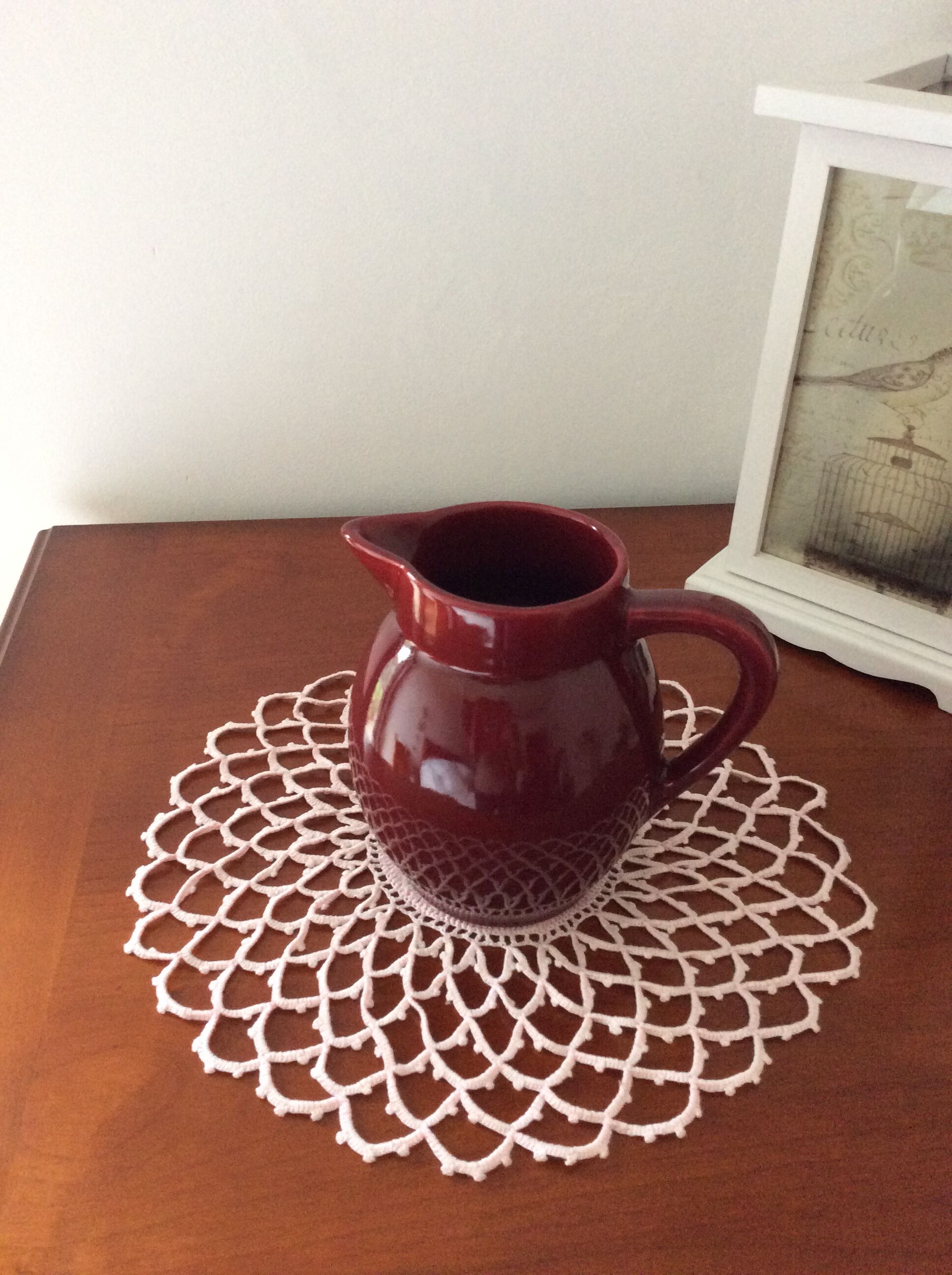 Old dark red ceramic pitcher jug