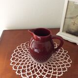 Old dark red ceramic pitcher jug