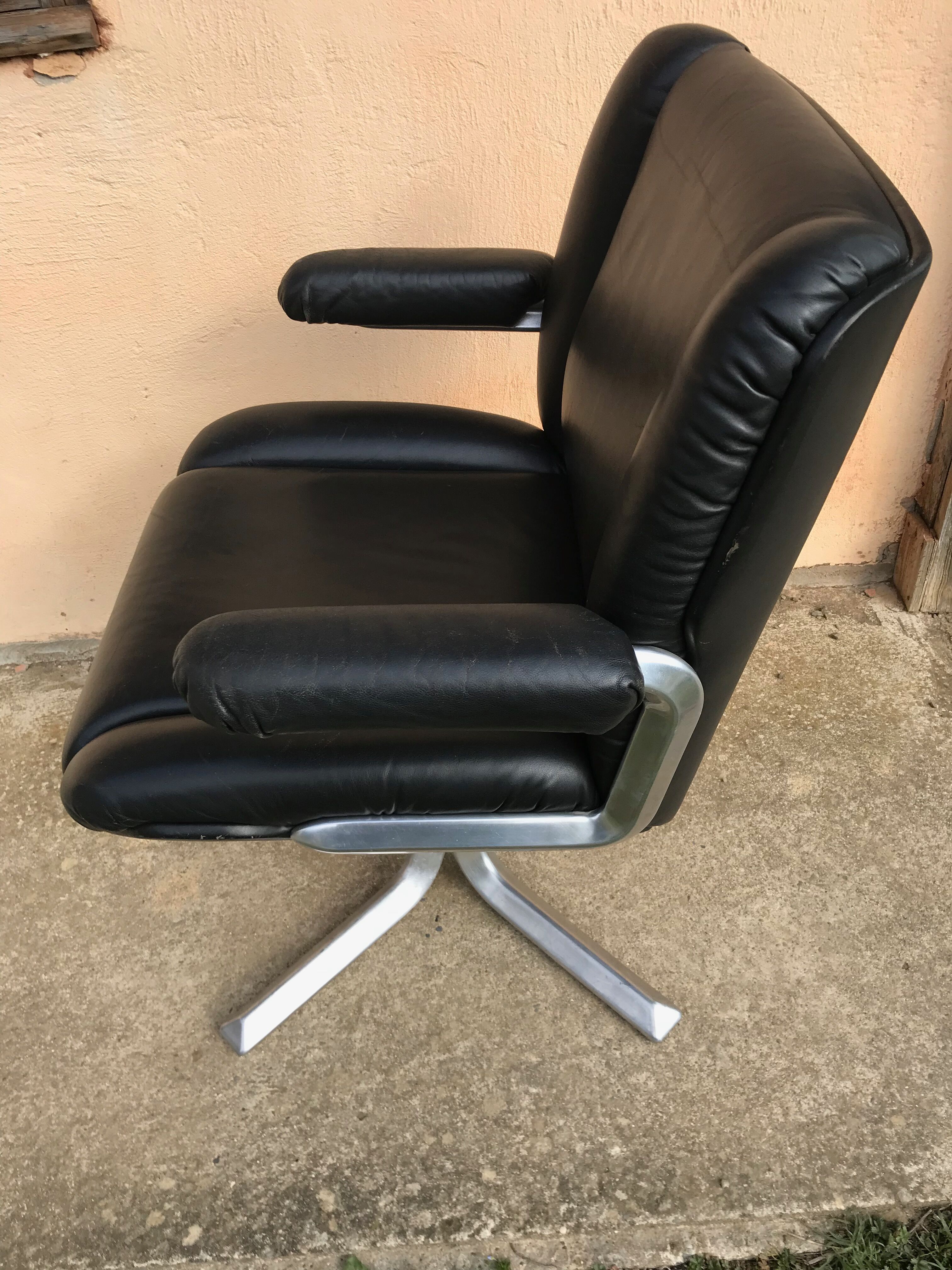 Vintage swivel black leather armchair