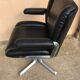 Vintage swivel black leather armchair