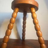 Round tripod stool in carved wood