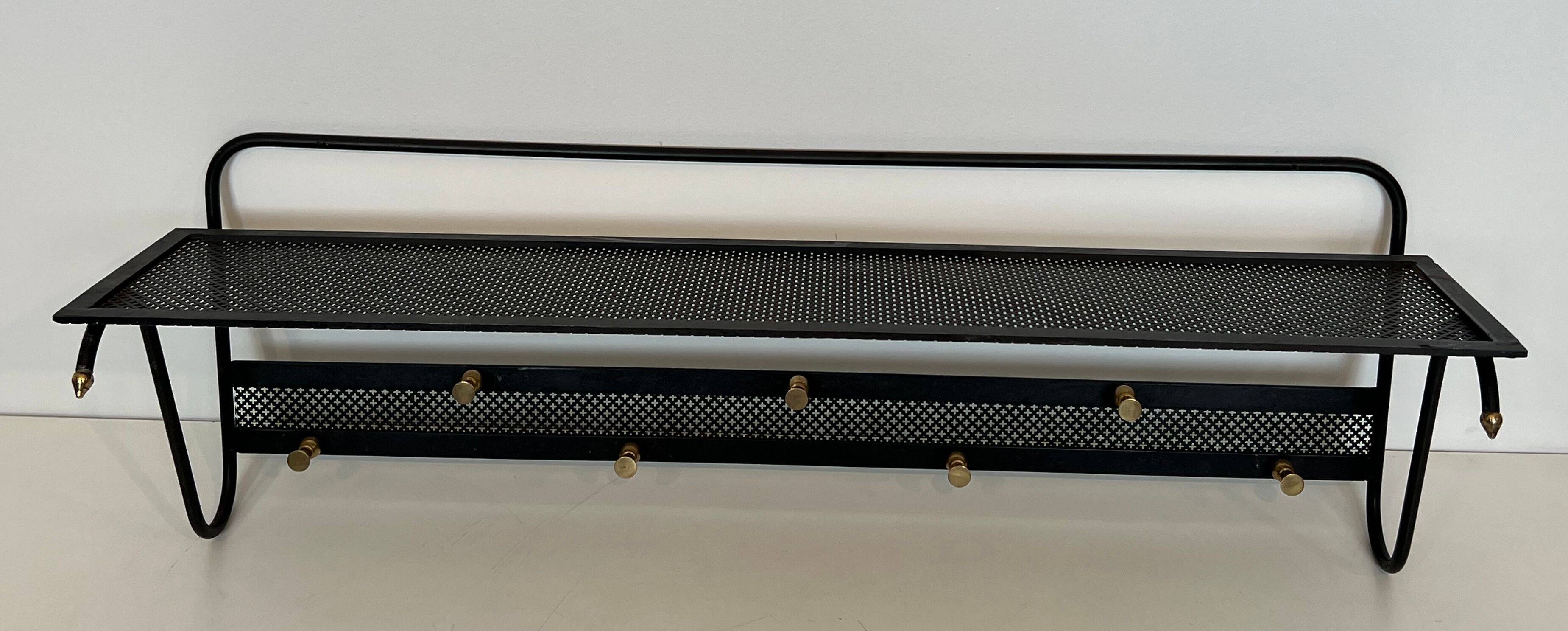 Coat rack in black lacquered metal, perforated sheet metal and brass in the style of Mathieu Matégot