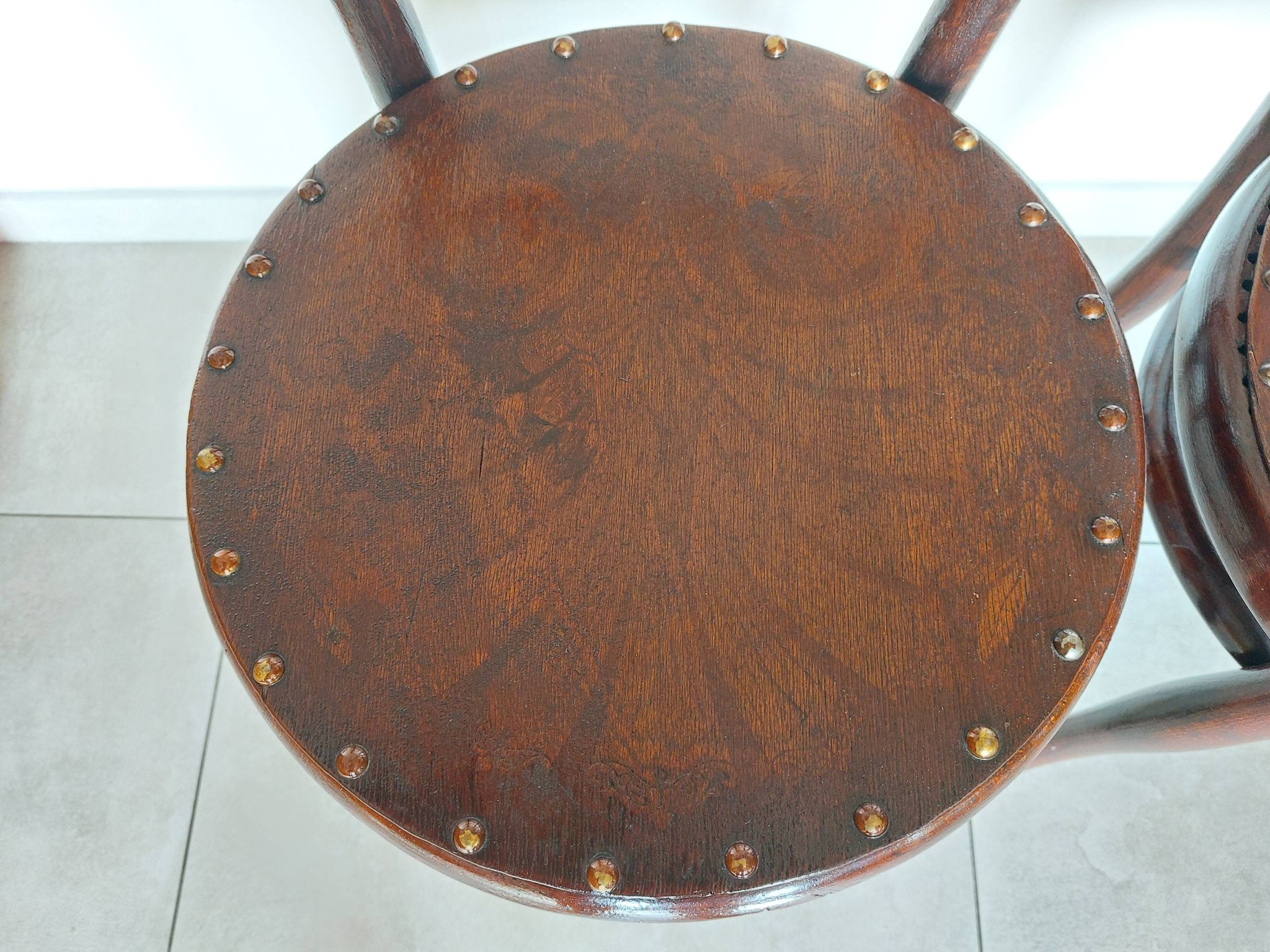 pair of round bistro chairs with a pattern on the seat, vintage