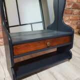 A renovated mirror in a wooden frame with a drawer and a shelf