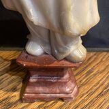 Soapstone sculpture on obsidian base of a Buddhist.