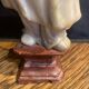 Soapstone sculpture on obsidian base of a Buddhist.