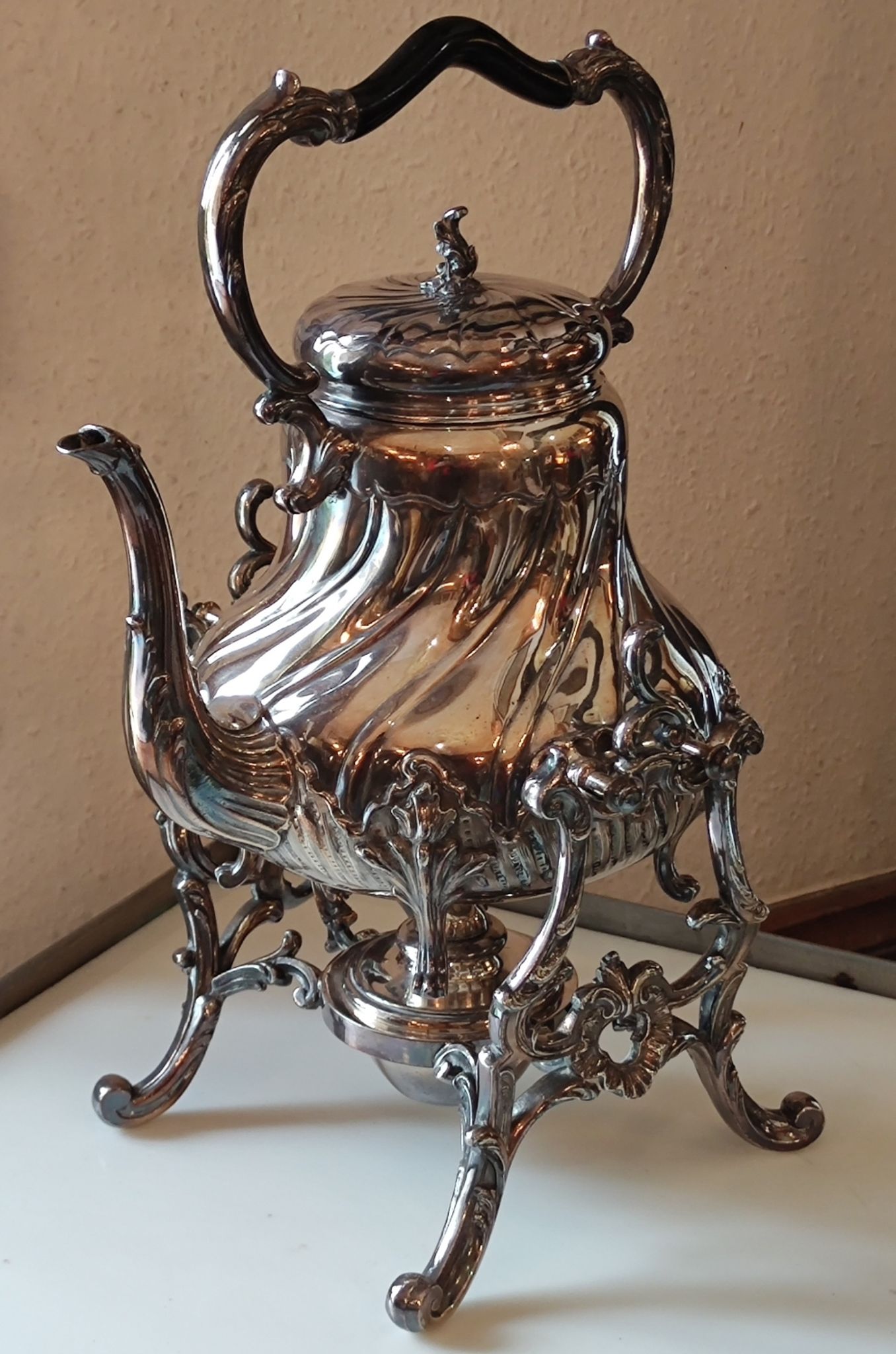 Ancient samovar tea fountain in silver metal
