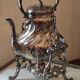 Ancient samovar tea fountain in silver metal