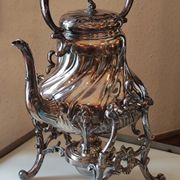 Ancient samovar tea fountain in silver metal