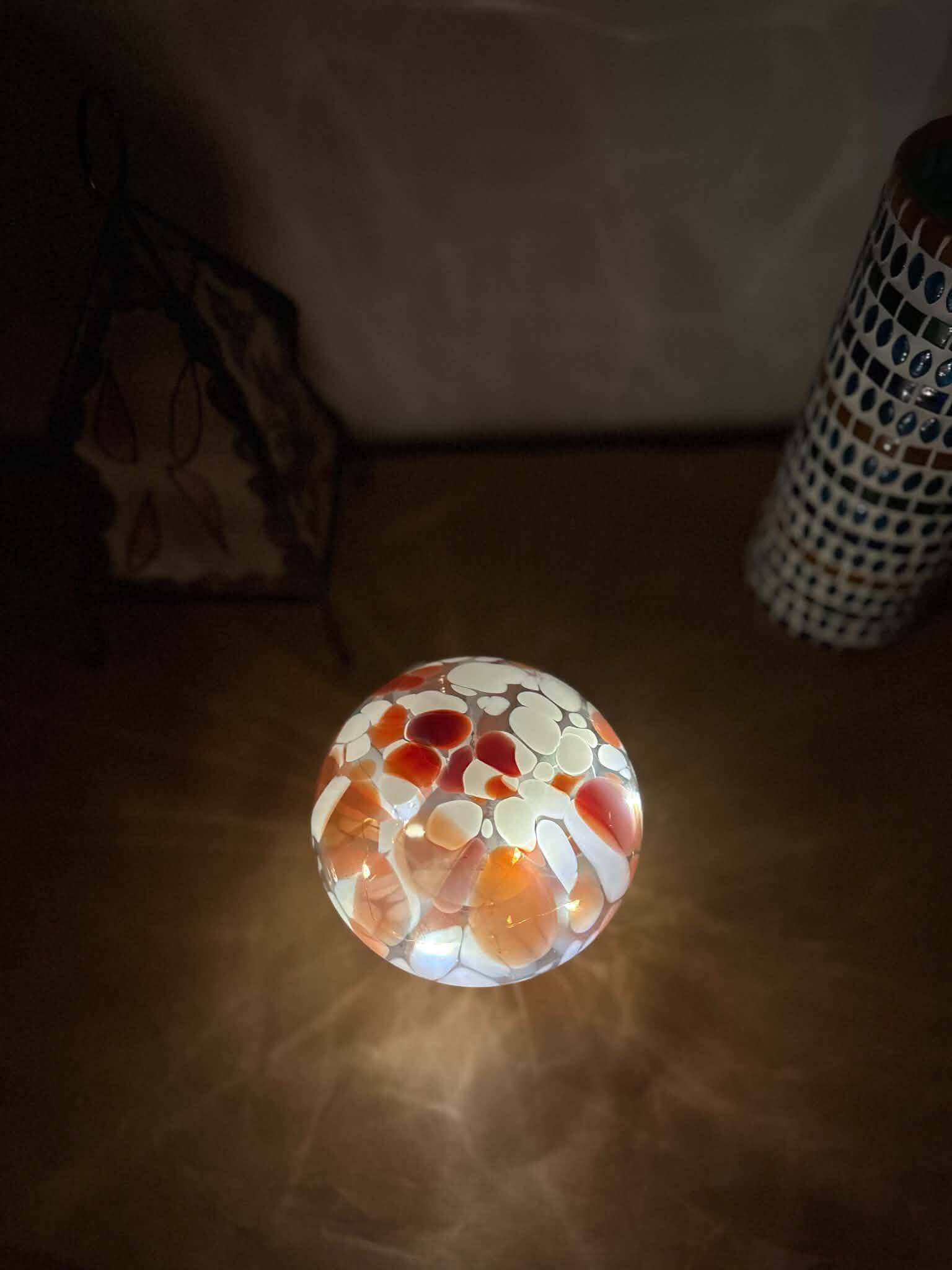 Mosaic glass mushroom lamp in orange, white, and clear.