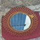 Vintage 1950s sun mirror in gold metal.