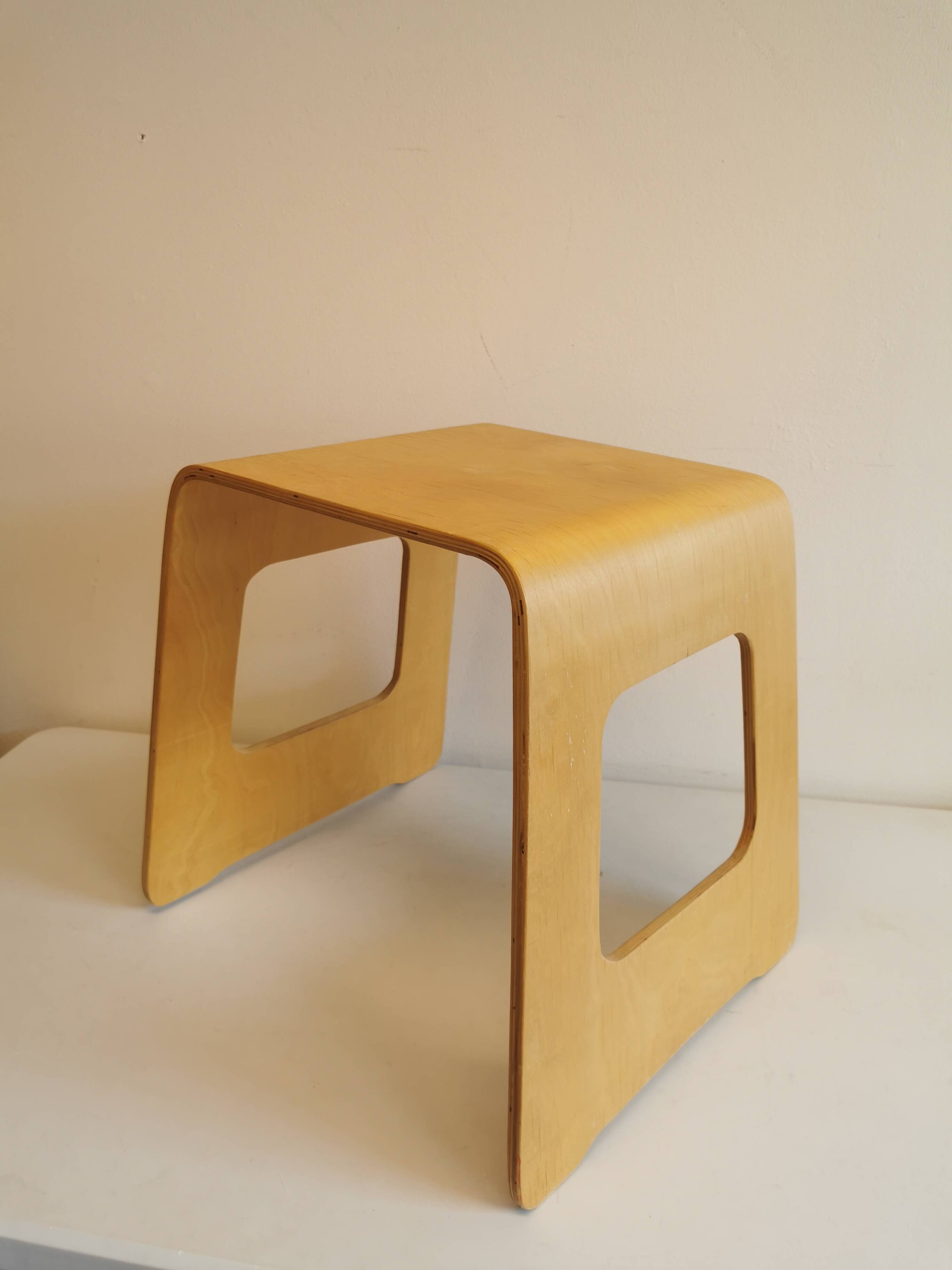 Design stool/side table made of curved plywood.