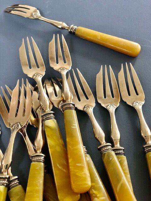 Brass and yellow galathite cake forks