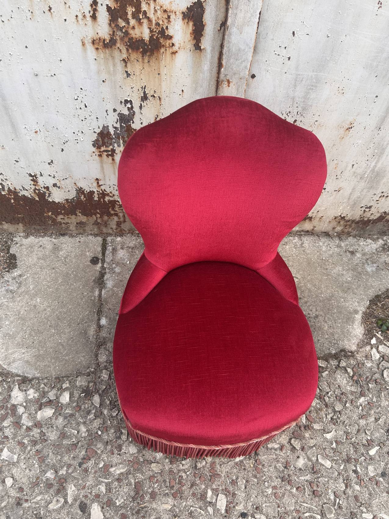 Vintage burgundy velvet armchair with fringes – theatrical and elegant