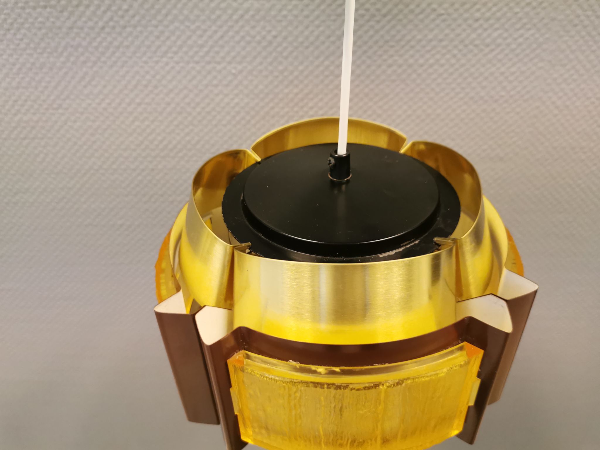 Danish hanging lamp, made in brass colored and brown metal, with yellowish hard pressed plastic deta