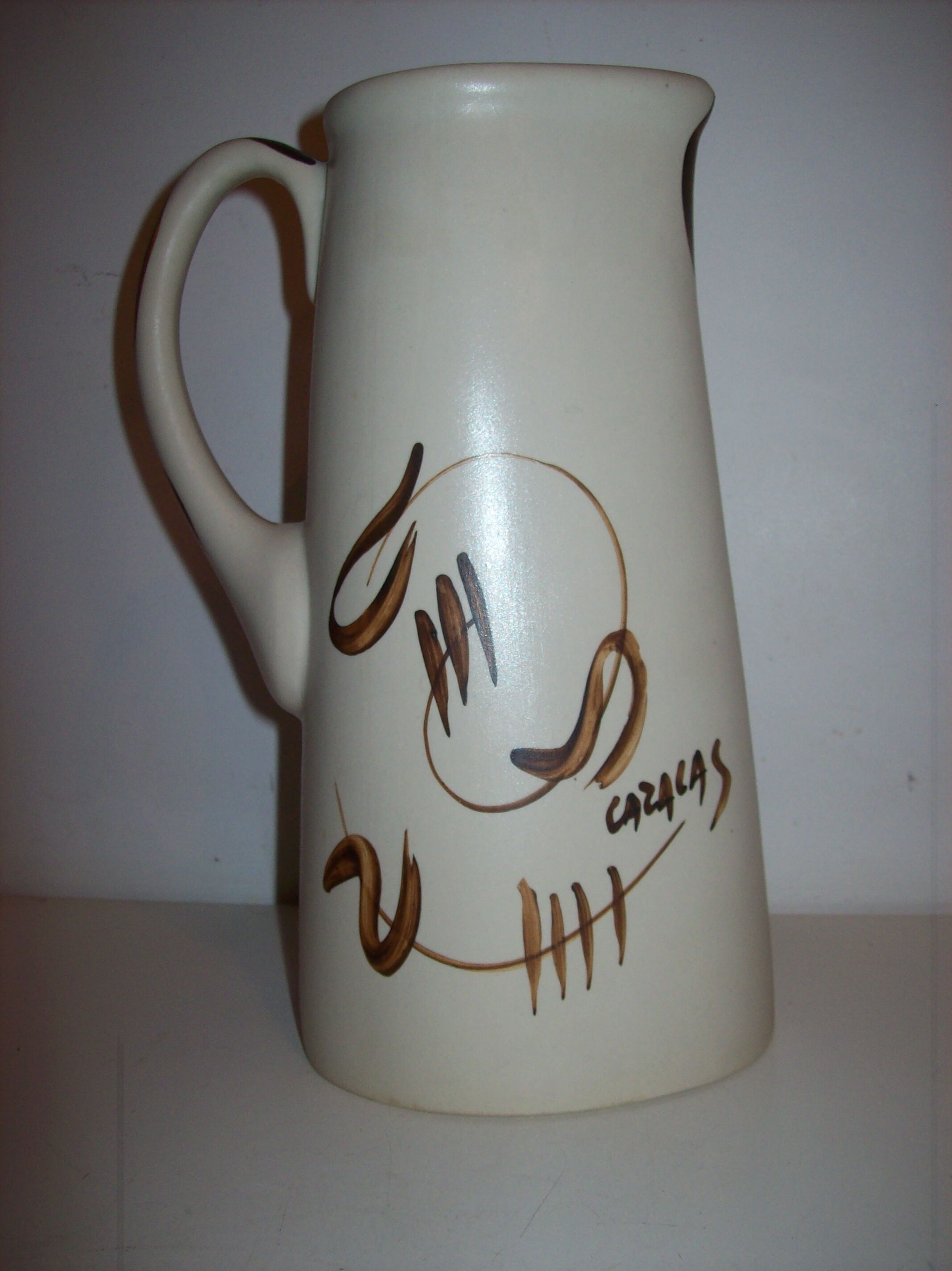 Ceramic pitcher with hand-painted decoration
