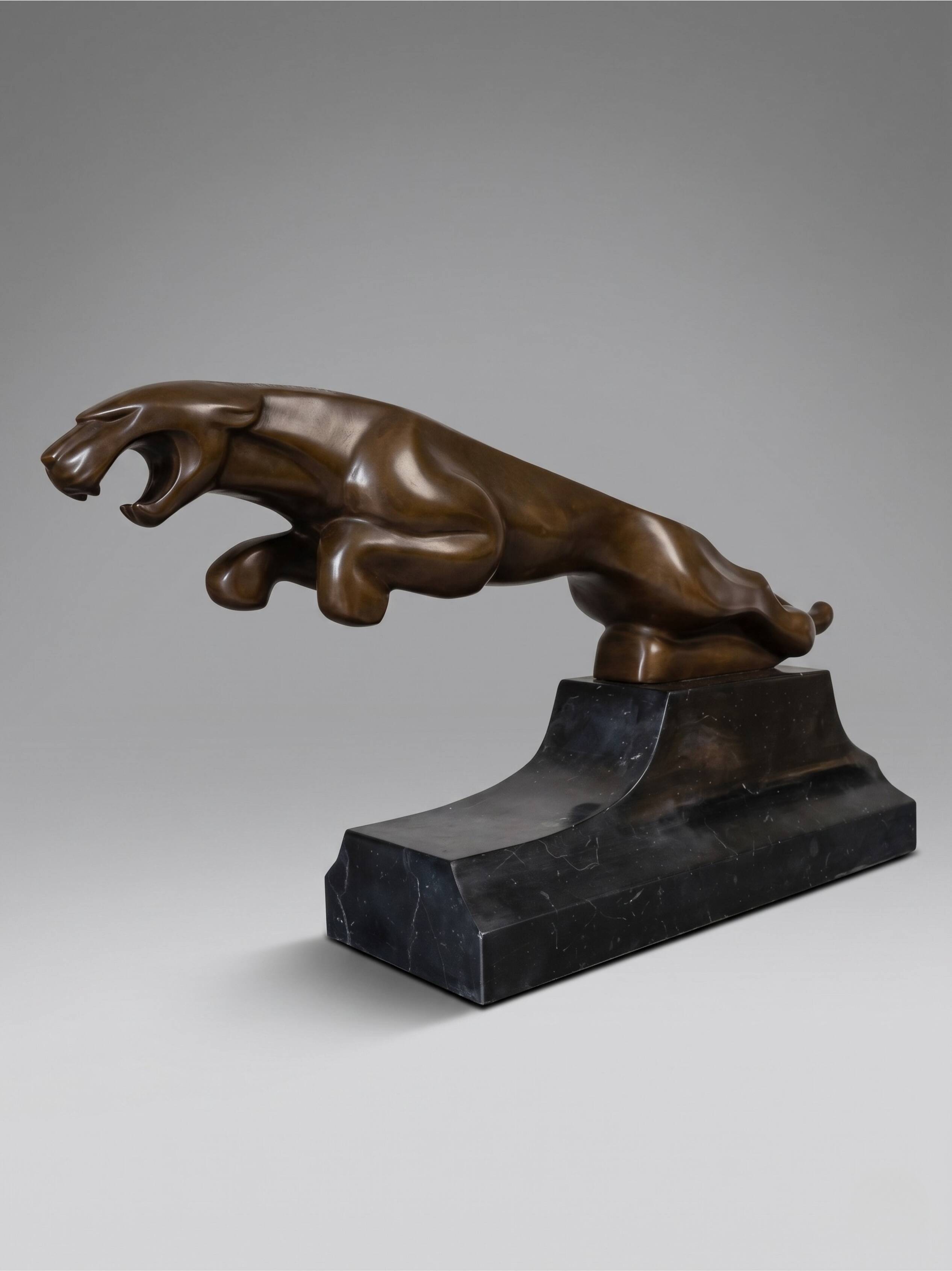 Large Art Deco bronze patinated Jaguar sculpture on an architectural base.