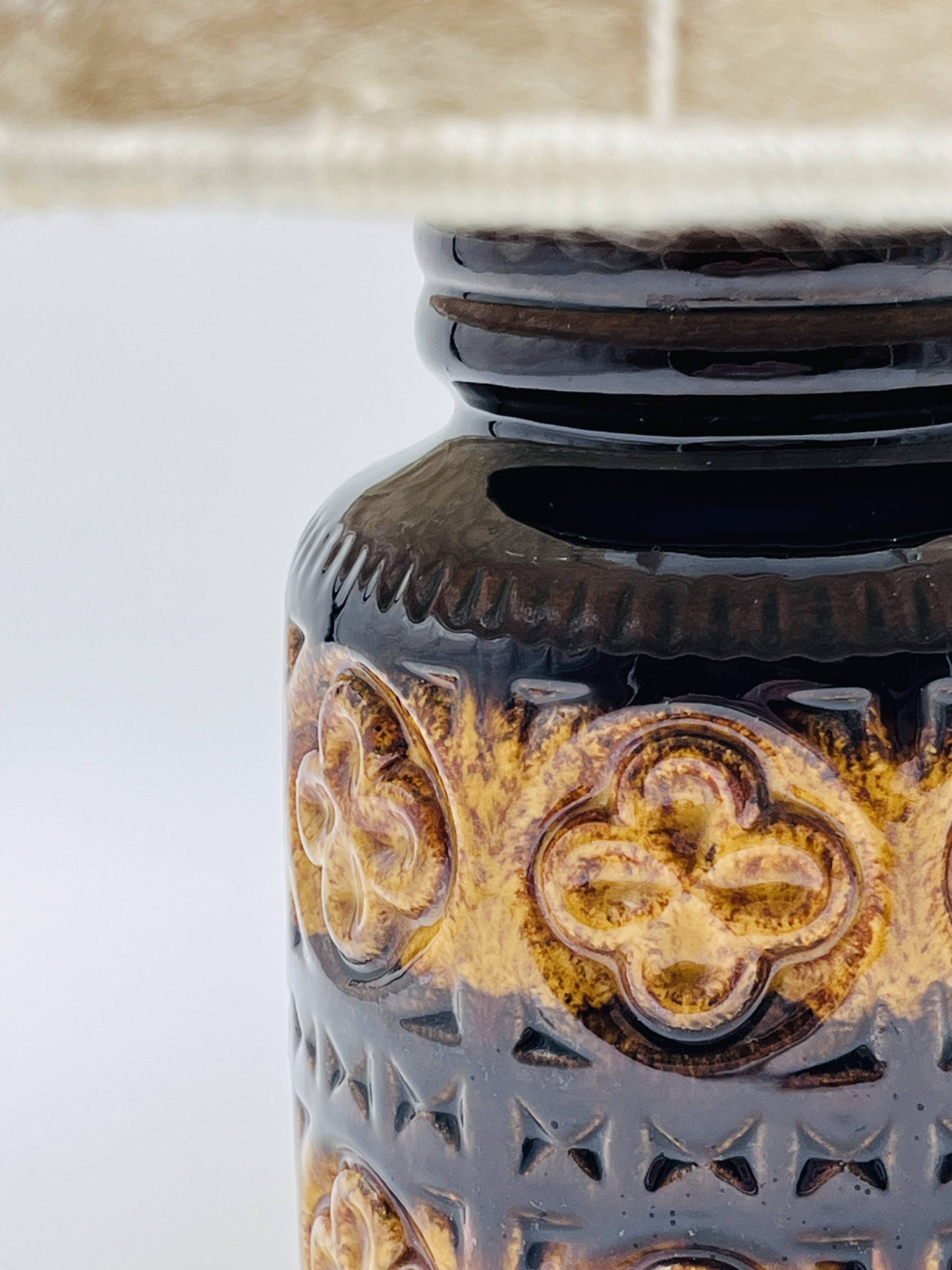 Vintage ceramic lamp with relief and wool shade.
