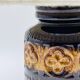 Vintage ceramic lamp with relief and wool shade.