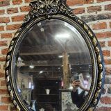 Ancien miroir ovale patiné noir et doré style louis xv