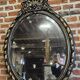 Old black and gold patinated oval mirror louis xv style