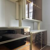 Wall-mounted and modular bookcase in lacquered brass, mirrors and smoked glass by Mahey, Design 1970
