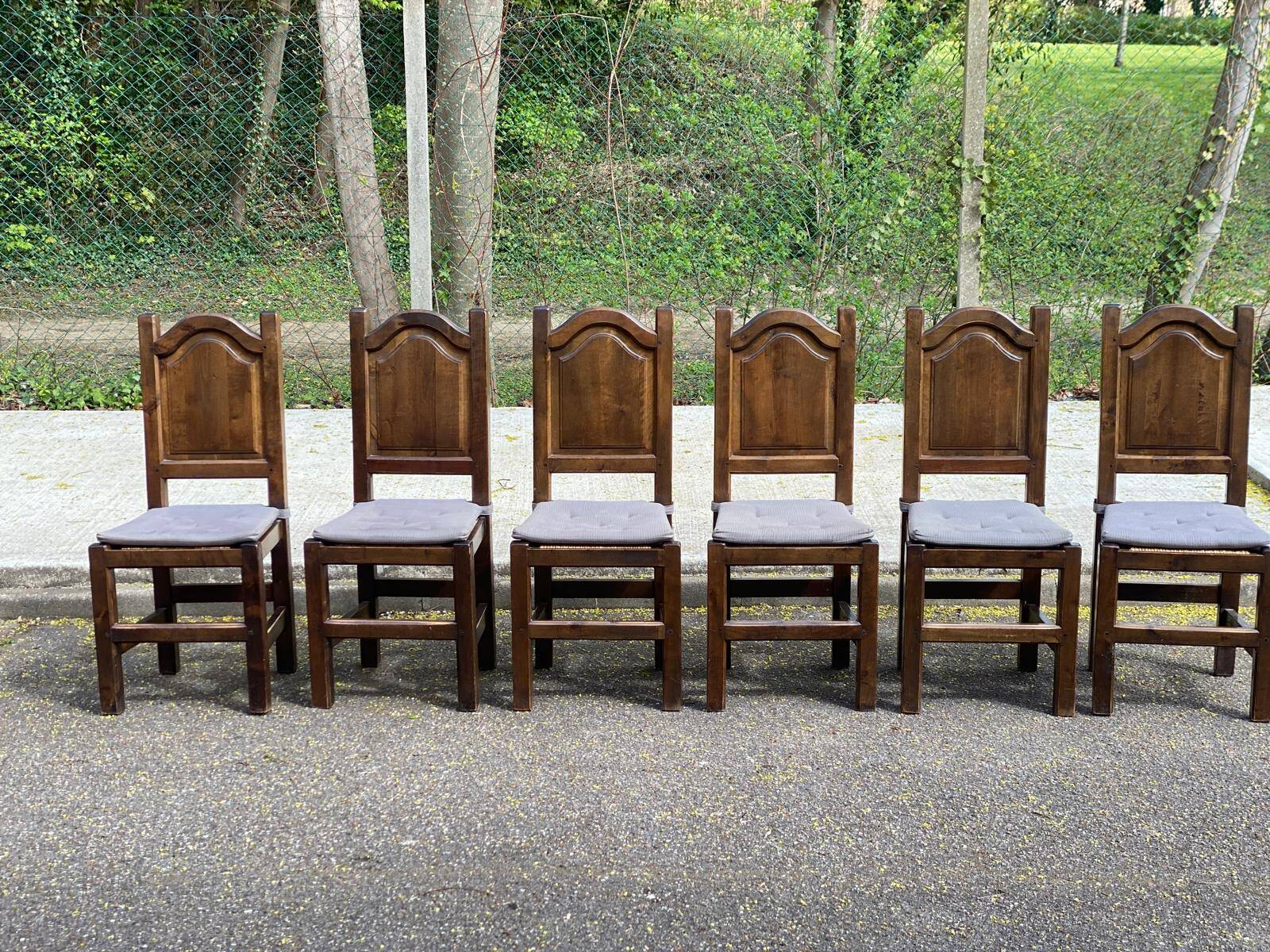 6 dining chairs in a country or farmhouse style, made of dark solid wood and rush-seated.
