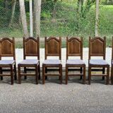 6 dining chairs in a country or farmhouse style, made of dark solid wood and rush-seated.