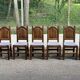 6 dining chairs in a country or farmhouse style, made of dark solid wood and rush-seated.
