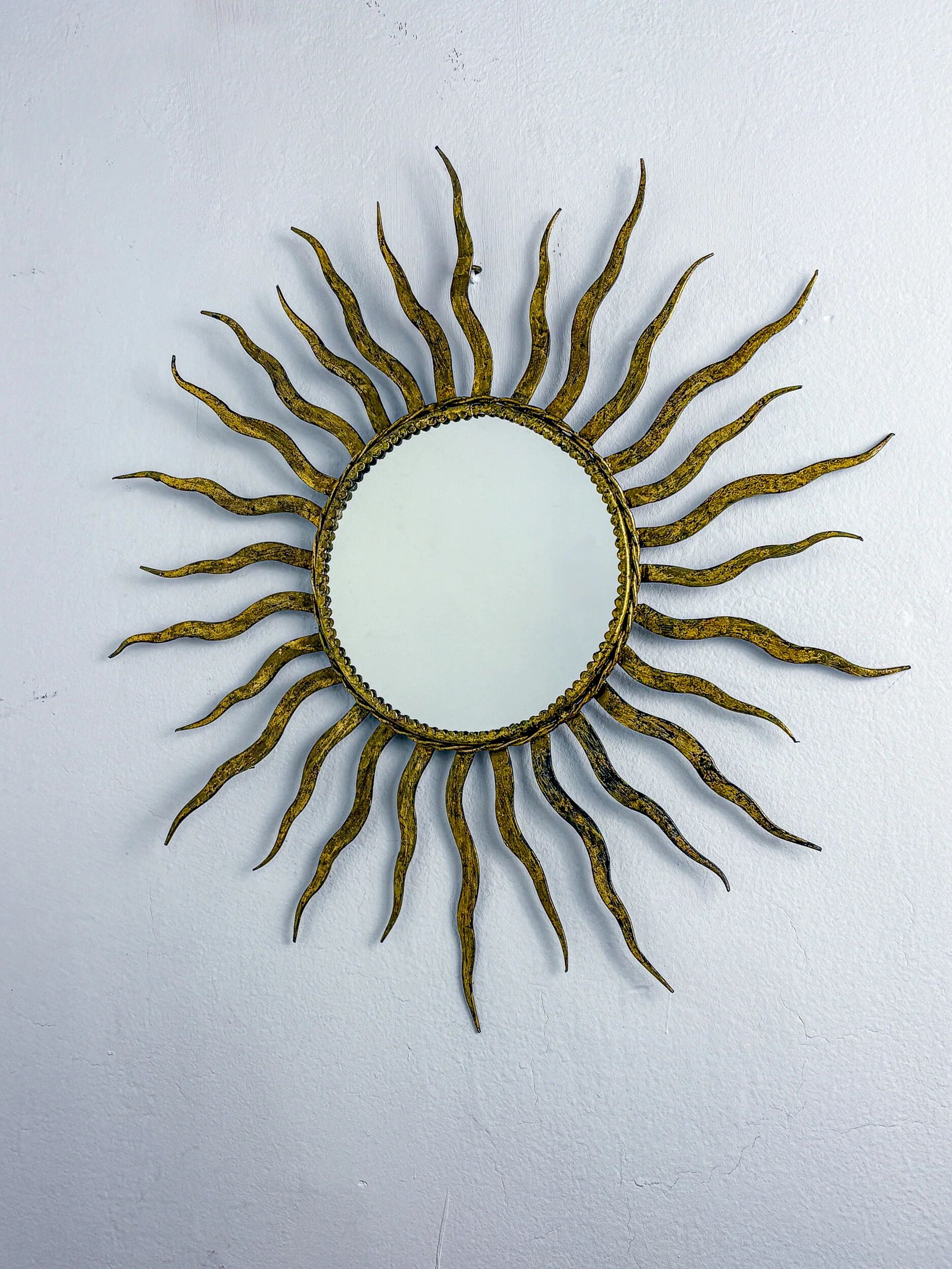 French sunburst starburst mirror in gilt iron, 1950s