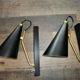 Pair of modernist sconces in black and gold metal
