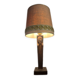 Old lamp with carved wooden base representing a wise man