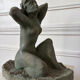 Sculpture of a naked woman titled "Youth" in terracotta.