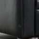 Set of a black cowhide leather Chesterfield armchair and matching ottoman