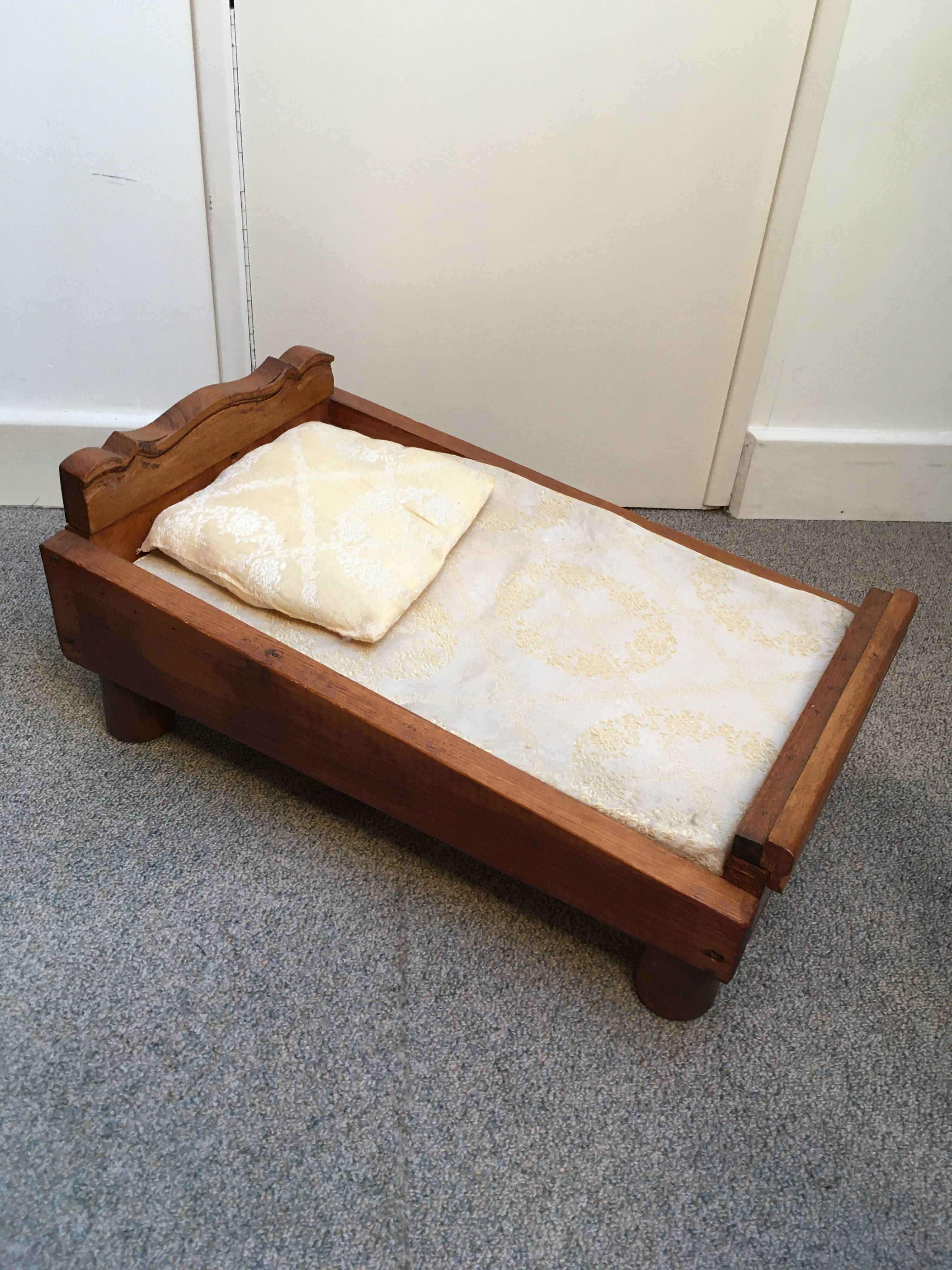 Old wooden bed for doll with mattress and pillow