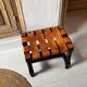 Antique turned wooden stool with woven leather.