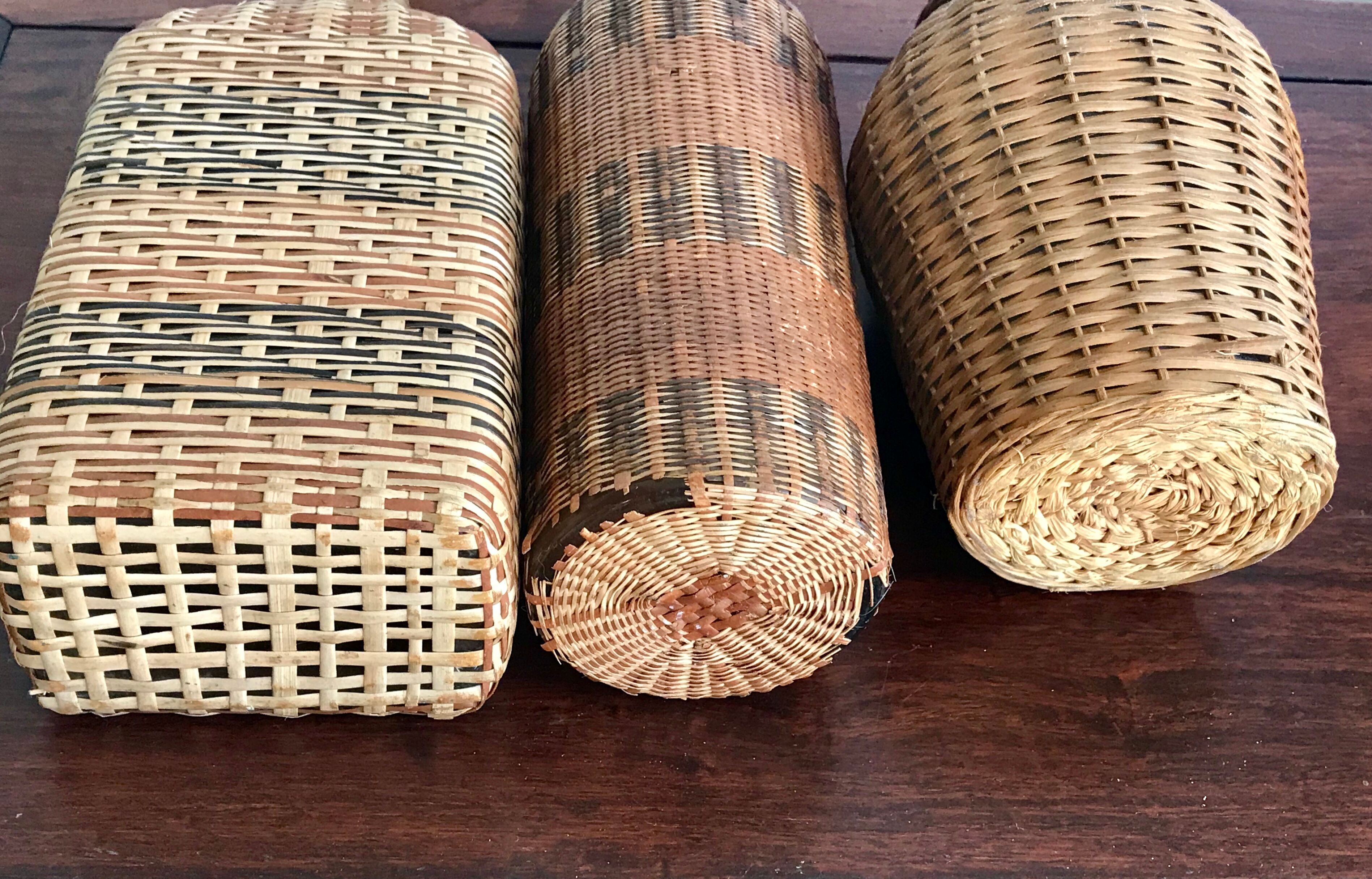 Set of three vintage rattan bottles
