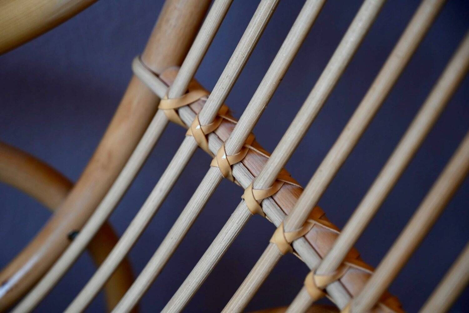 Vintage rocking chair in rattan from the 60s-70s, high openwork backrest.