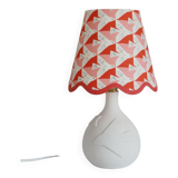 Small lamp with matte finish ceramic base and printed scalloped lampshade