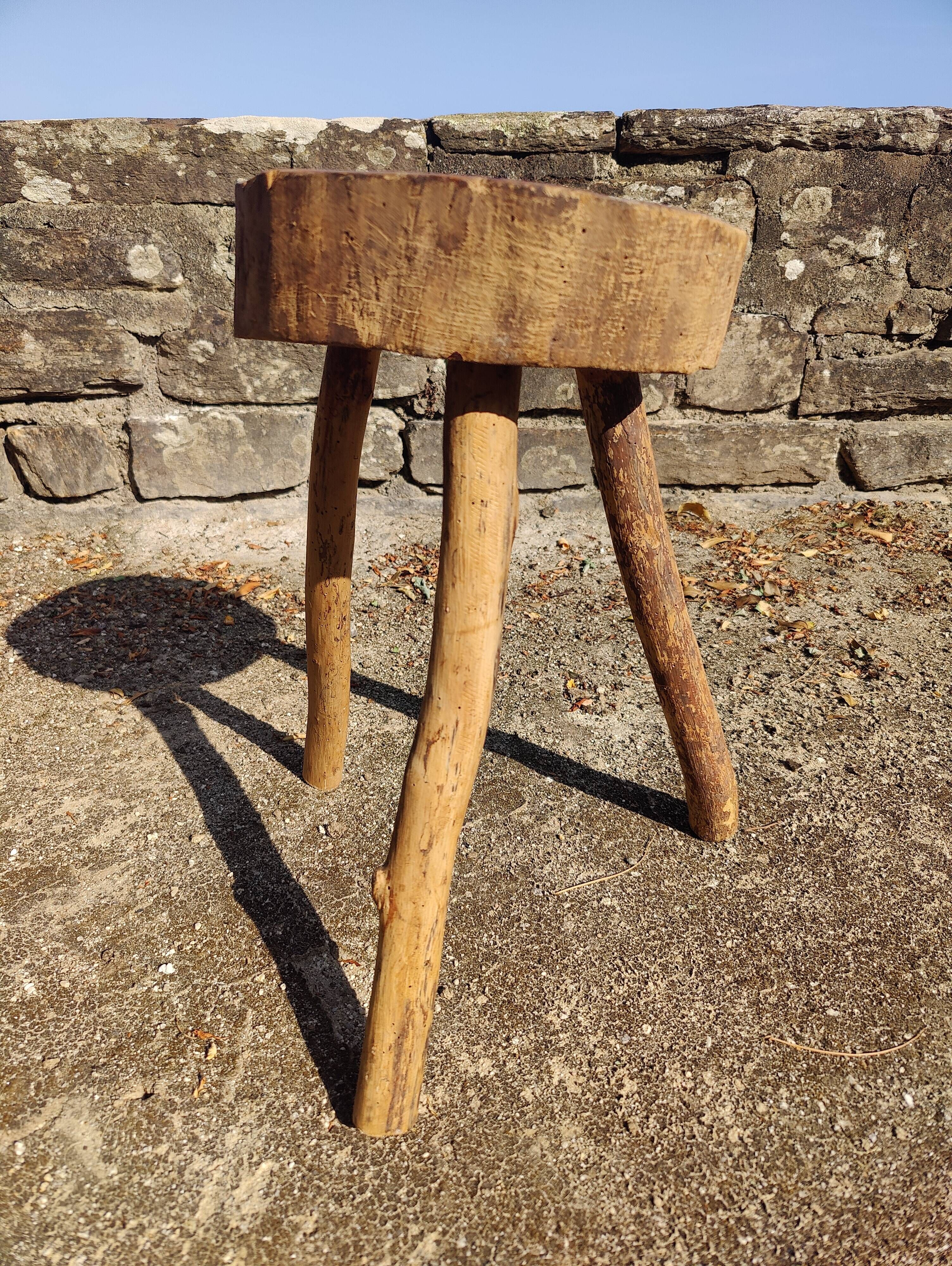 Rustic three-legged stool in minimalist wood in the style of Touret.