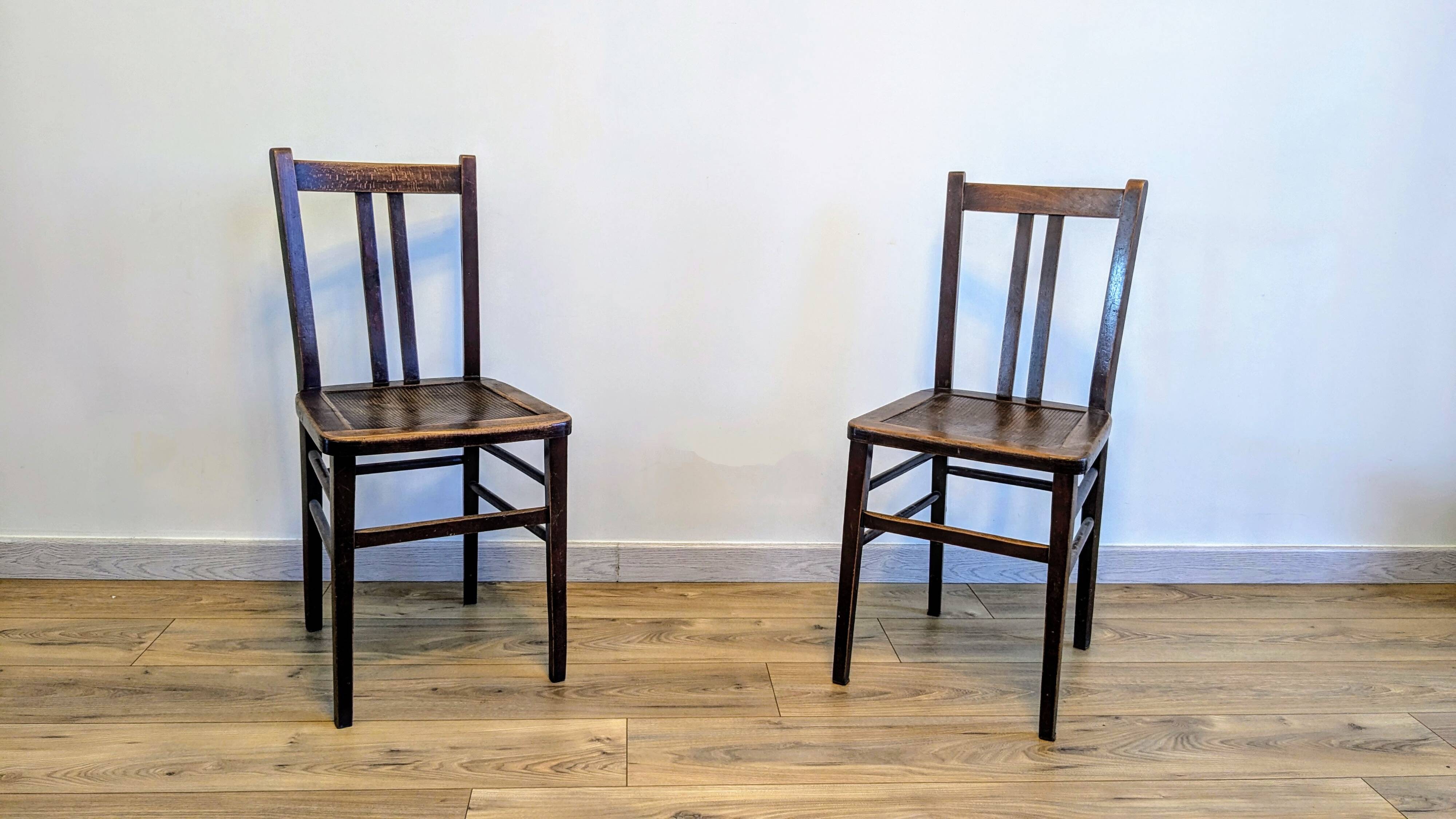 Pair of 1930s bistro chairs with patinated wood.