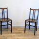 Pair of 1930s bistro chairs with patinated wood.