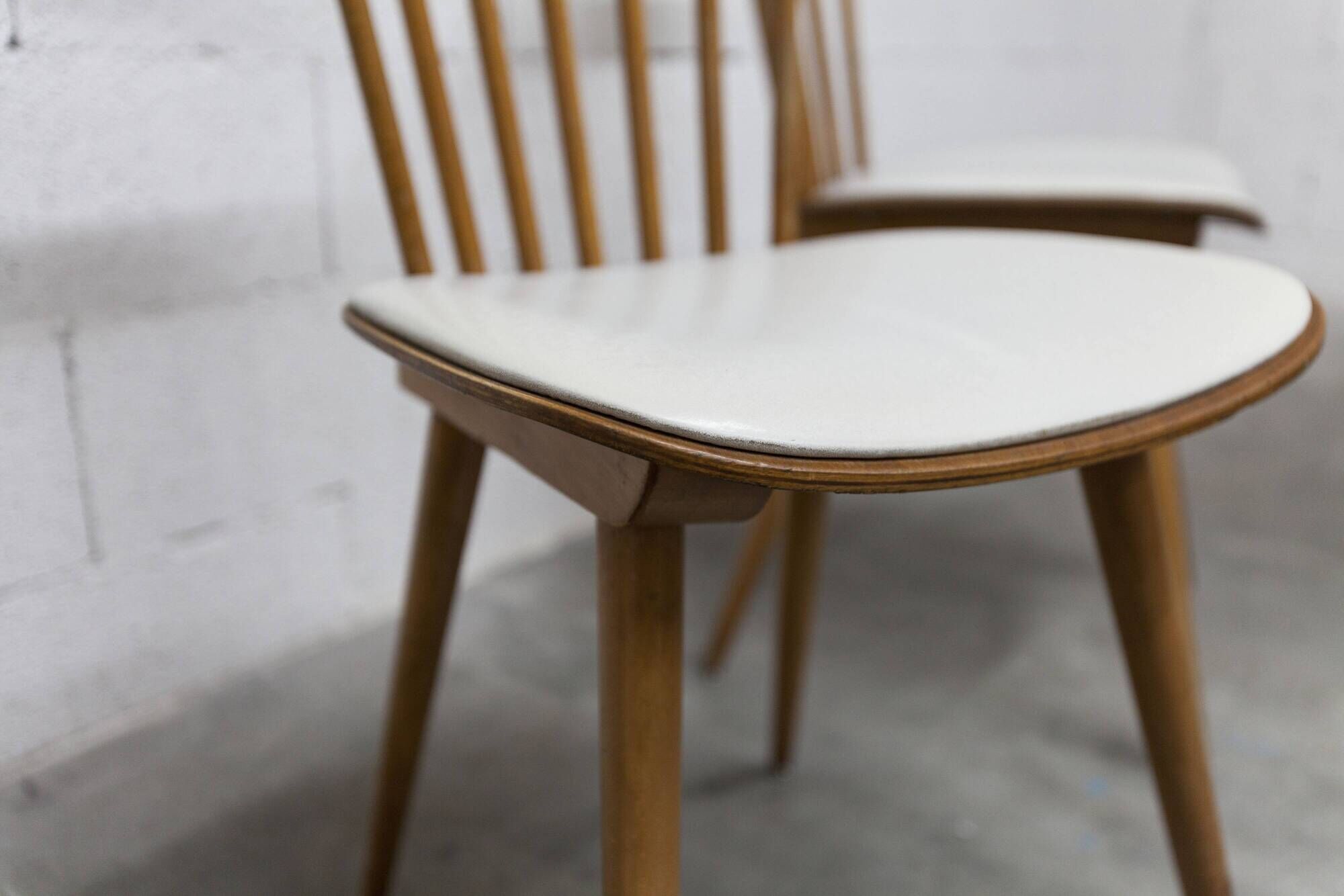 Pair of Baumann Menuet chairs, Honey patina, White skai seat