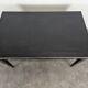 Large flat desk in Louis XVI style, black lacquered with gold highlights.