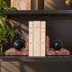 Pair of red marble bookends with black stone spheres – Art Style