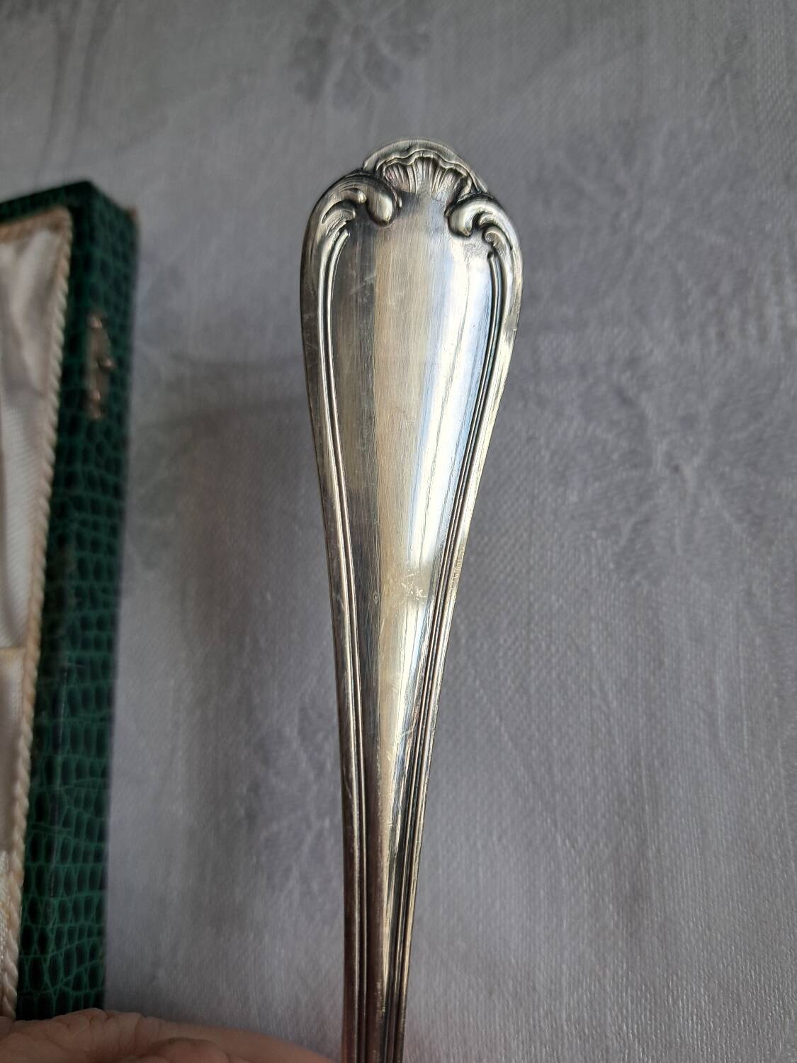 Silver metal cake peeler.